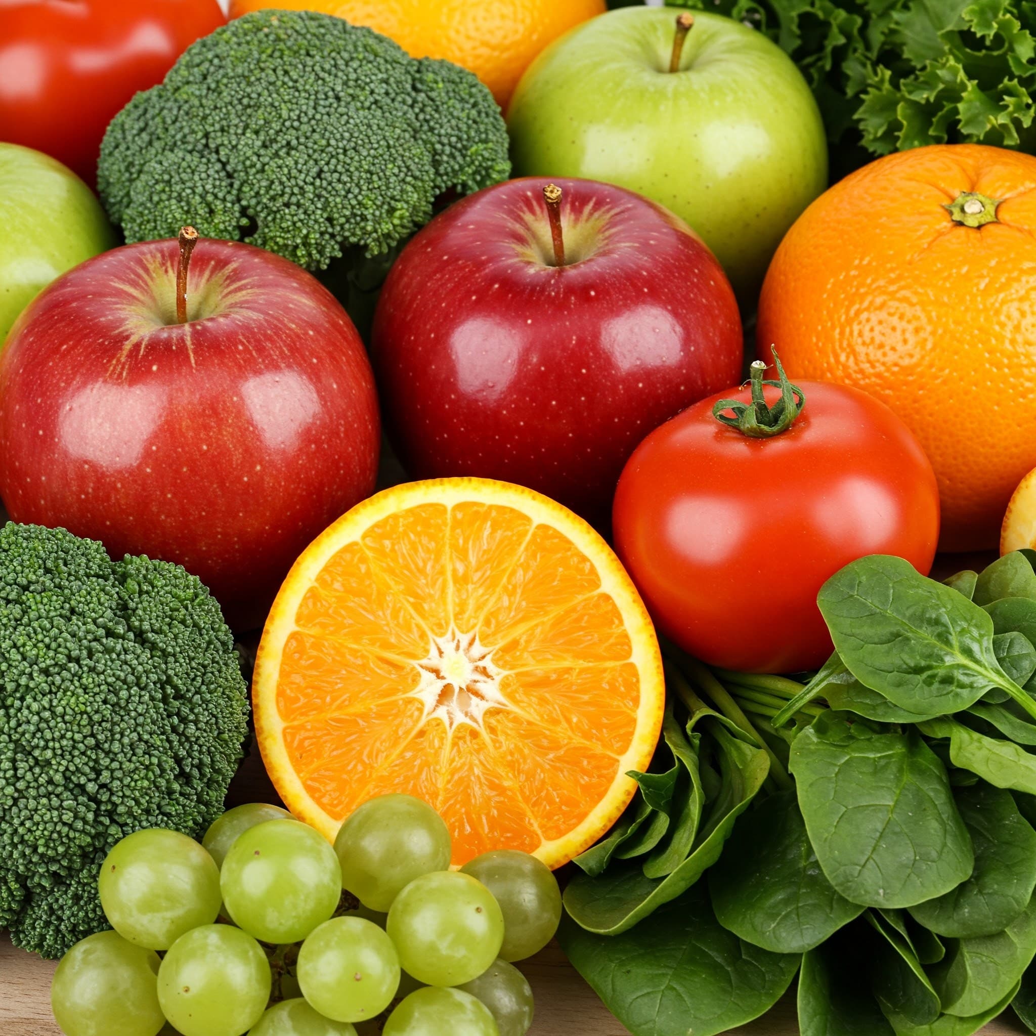 Fresh fruits and vegetables including apples, oranges, broccoli and spinach